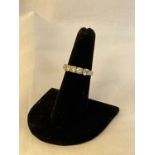 A white metal five stone diamond ring, each four claw set brilliant cut stone weighing approx. 0.