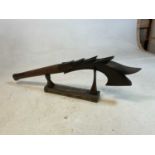 A contemporary carved wooden ceremonial war club with stand, from the Polynesian original. Length: