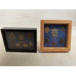 Two small framed and glazed displays of cap badges, including Hood, Howe, also a Royal Marines