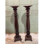 A pair of late 19th century mahogany torchere columns, each with dished circular top above