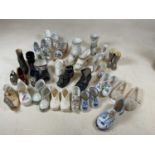 A collection of ornamental ceramic shoes, many being Continental examples.