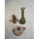 A Roman green tinted glass teardrop vase, height 11.5cm, an early Turkish lamp, length 7.75cm, and
