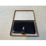 GUCCI: an original boxed 1973 black leather purse, width 13.5cm
