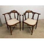 A pair of Edwardian inlaid corner chairs.