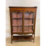 An Edwardian mahogany inlaid and chequered strung display cabinet with twin glazed doors above