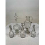 19th century glassware comprising three matching decanters with engraved grapes and vine and a
