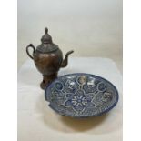 A Middle Eastern coffee dallah coffee pot and a Middle Eastern blue painted ceramic bowl.