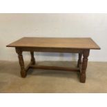 An oak refectory table with central stretcher, height 76cm, width 168cm, depth 76cm.