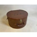 A large vintage leather trimmed hat box bearing initials 'J.F.H', with floral lined interior, and