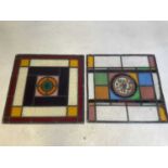 Two leaded stained glass panels, each centred with a Victorian glass roundel, each approx. 52 x