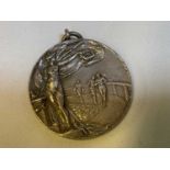 An early 20th century leather cased hallmarked silver medallion for running, uninscribed, the