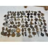 Approximately one hundred original military cap badges, including 19th (Alexandra PWO) Hussars,