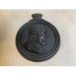 A mid 19th century cast iron plaque set with the profile portrait of the Duke of Wellington, the