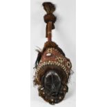 TRIBAL ART; a carved wooden dance mask with applied metal and cowrie shell decoration, total