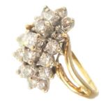 A 14ct gold diamond cluster ring with central line of seven claw set diamonds flanked with row of