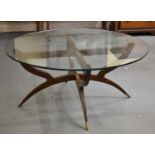 A stylish mid century teak spider type coffee table with circular glass top, diameter 105cm.