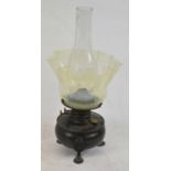 An early 20th century oil lamp with Vaseline tinted shade, height to top of chimney 41cm.