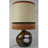 A 1970s designer table lamp of abstract form, probably American, height 36cm, with shade.