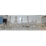 A large quantity of cut and crystal glassware including Stuart Crystal glasses and four decanters.