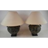 A pair of decorative bronzed table lamps in the Chinese style, height 36cm.