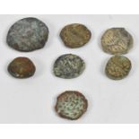 Seven assorted ancient Islamic coins.