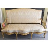 A late 19th century French giltwood canape with serpentine seat, scroll arms and scrolling feet.