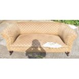 A Victorian Chesterfield sofa for re-upholstery, on turned supports, width 180cm.