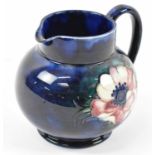MOORCROFT; a blue ground jug decorated in the 'Anemone' pattern.