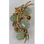 A 14ct yellow gold brooch set with four green stones, approx 20.6g.