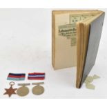A group of three World War II medals including The Defence Medal, The Star, and a scrap book of