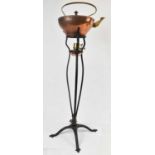 BENSON&CO; A copper kettle on a cast iron stand, height 84cm.