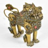 An early 20th century Tibetan brass scent bottle modelled as a Dog of Fo, set with turquoise and