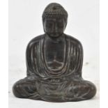 A Chinese bronze figure of a seated Buddha, engraved character marks to base, height 12cm.