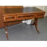 A reproduction writing table, the leather lined top above three frieze drawers, width 122cm.