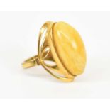 An 18ct yellow gold dress ring set with large central yellow stone, size O, approx 4.6g.