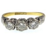 A Victorian 18ct gold and platinum three stone diamond ring, the central stone approx. 0.2ct,