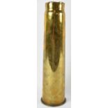 A brass shell case, height 42cm.