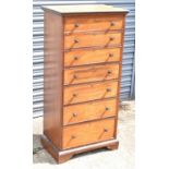 DRUCE & CO; an Edwardian mahogany and crossbanded narrow chest of seven drawers on bracket feet,