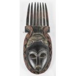 TRIBAL ART; an African carved wooden comb mask, height 51cm.
