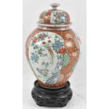 A large Japanese baluster form jar decorated with birds amongst foliage, with cover, height 34cm,