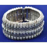 An Indian silver and blue sapphire articulated broad bracelet, width 3cm.