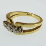 A contemporary 18ct gold diamond ring set with five graduated diamonds, the principal stone