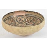 An ancient painted earthenware footed bowl, probably Afghanistan, diameter 20cm.