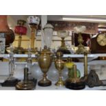 A collection of oil lamps and parts, to include eight oil lamps, a pair of glass candlesticks,