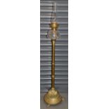 An early 20th century brass standard oil lamp with clear glass reservoir and chimney, height 132cm