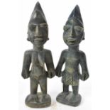 TRIBAL ART; a pair of 20th century tribal carvings, height 30cm.