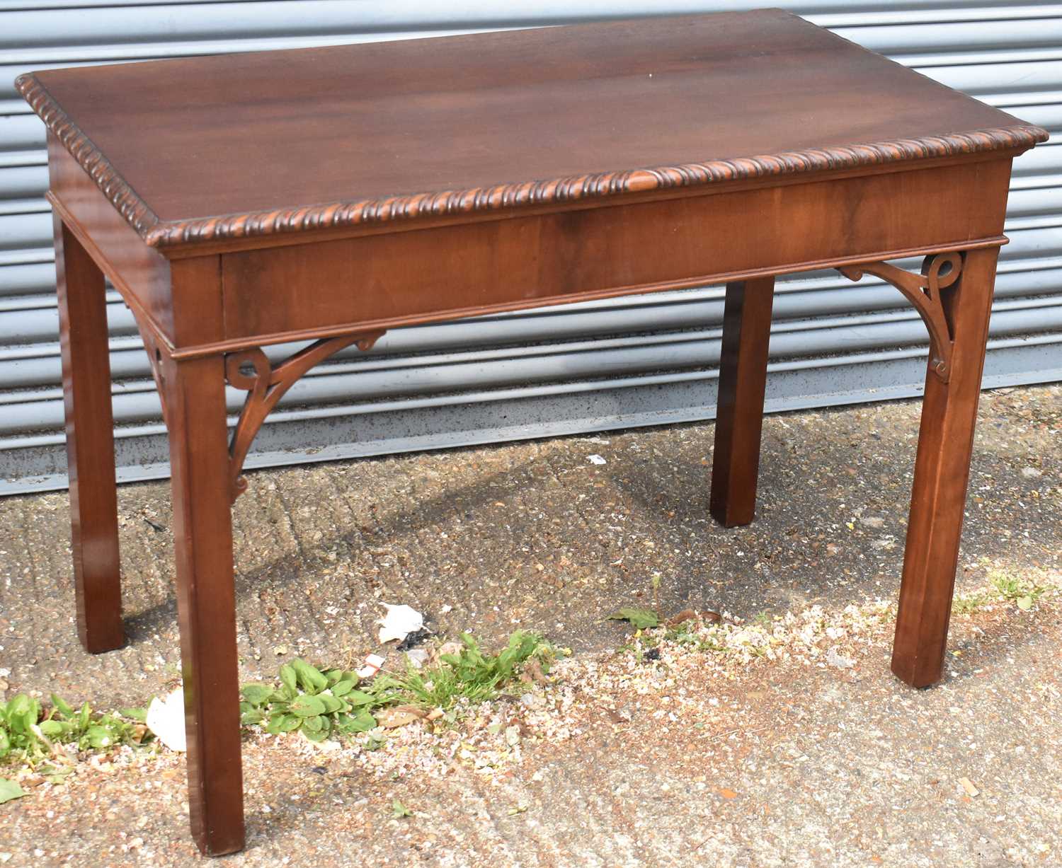 A 19th century mahogany hall table in the Chippendale style with rectangular top on square supports,