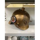 A reproduction German brass helmet.