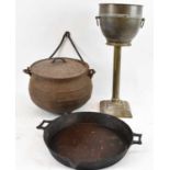 A cast iron cauldron with cover and swing handle, diameter 33cm, a cast iron pan with pouring spout,