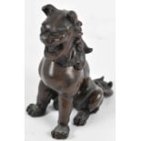 A Chinese bronzed metal figure of a Dog of Fo, seal mark to base, height 12.5cm.